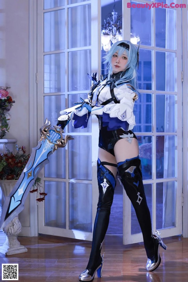 A woman in a blue and white outfit holding a sword.