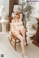 A woman sitting on a rocking chair in a room.