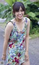 A woman in a colorful dress posing for a picture.