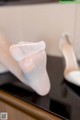 A pair of white shoes sitting on top of a table.